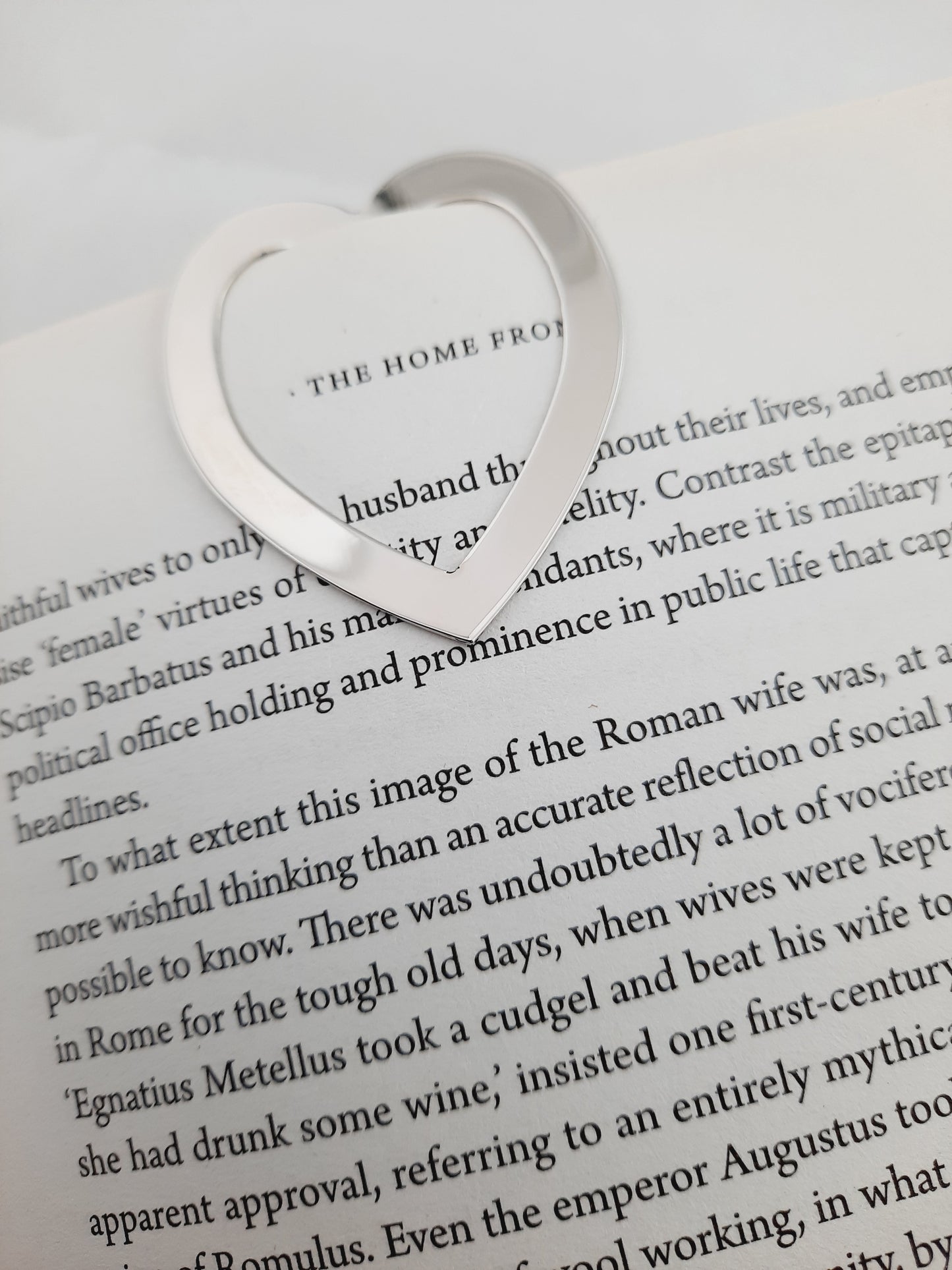 Love heart shaped bookmark in one of book page.