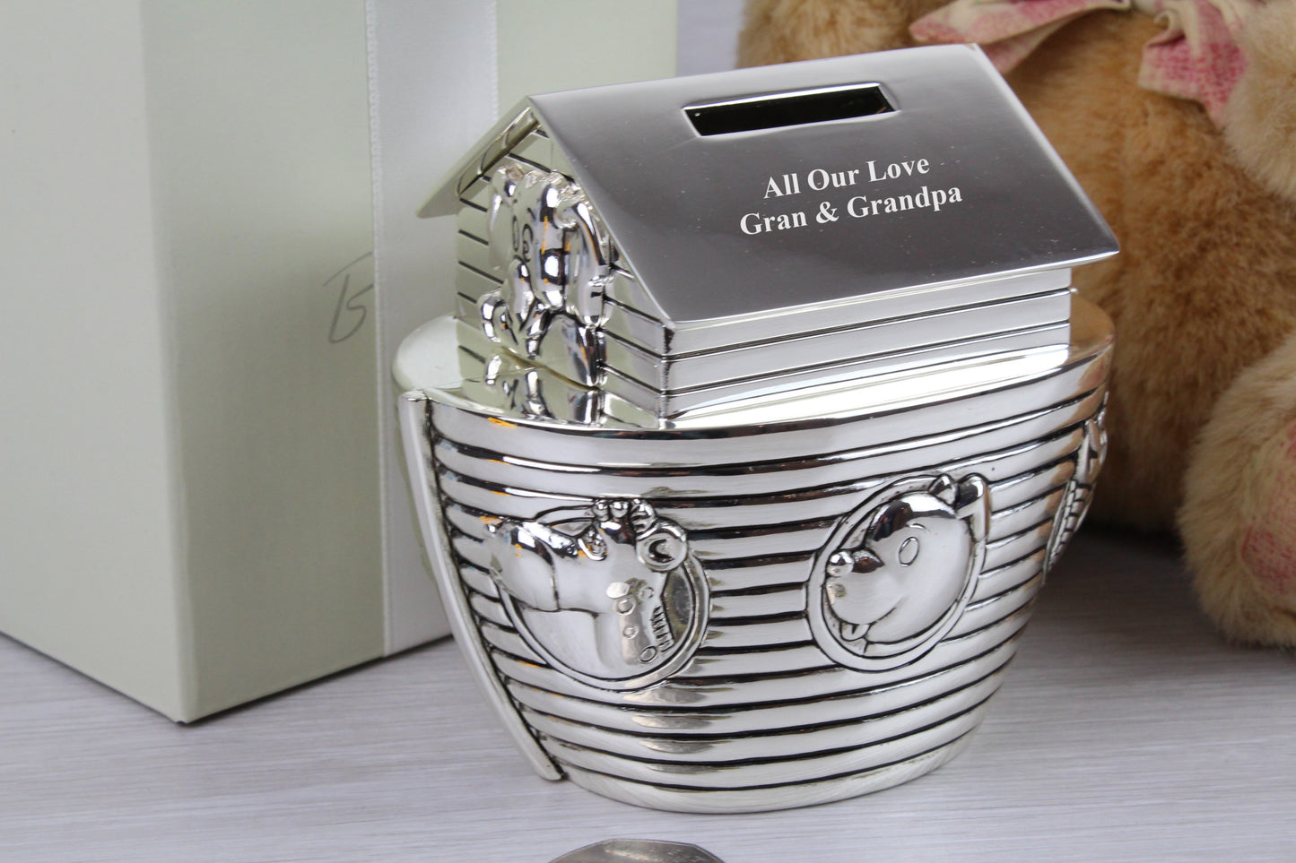 A close up shot of Engraved Noah's Ark Money Box that says "All Our Love Gran & Grandpa"