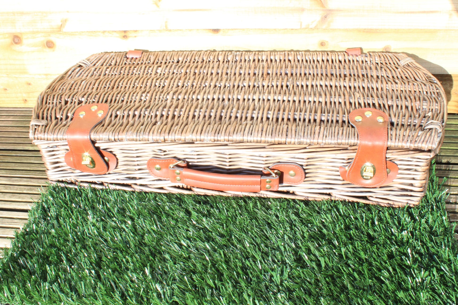 The sun shines in the case of Personalised Barbecue Tools that sit on faux grass.