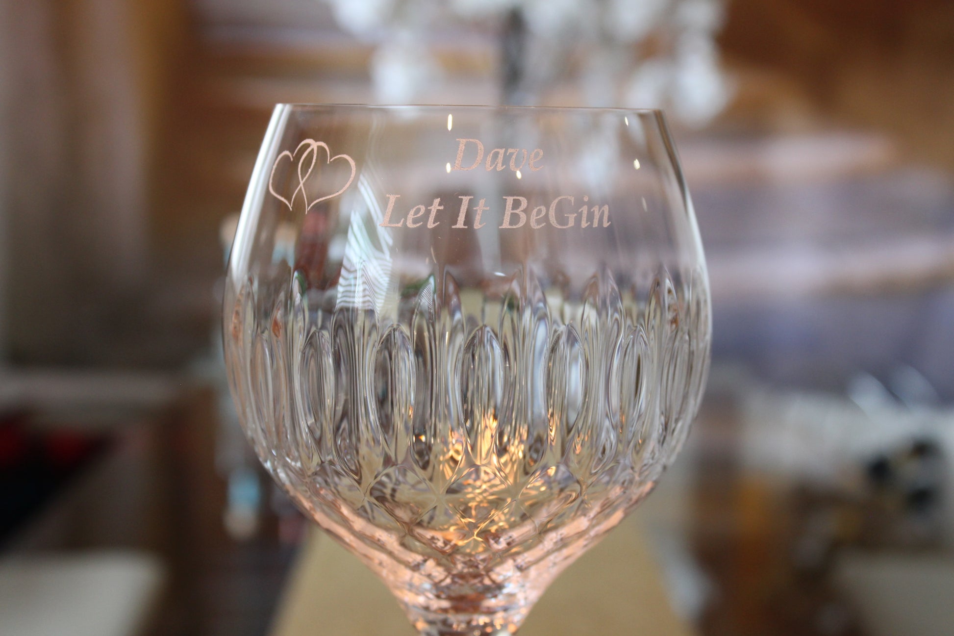 Half picture shot of the gin glass focusing on the engraved words