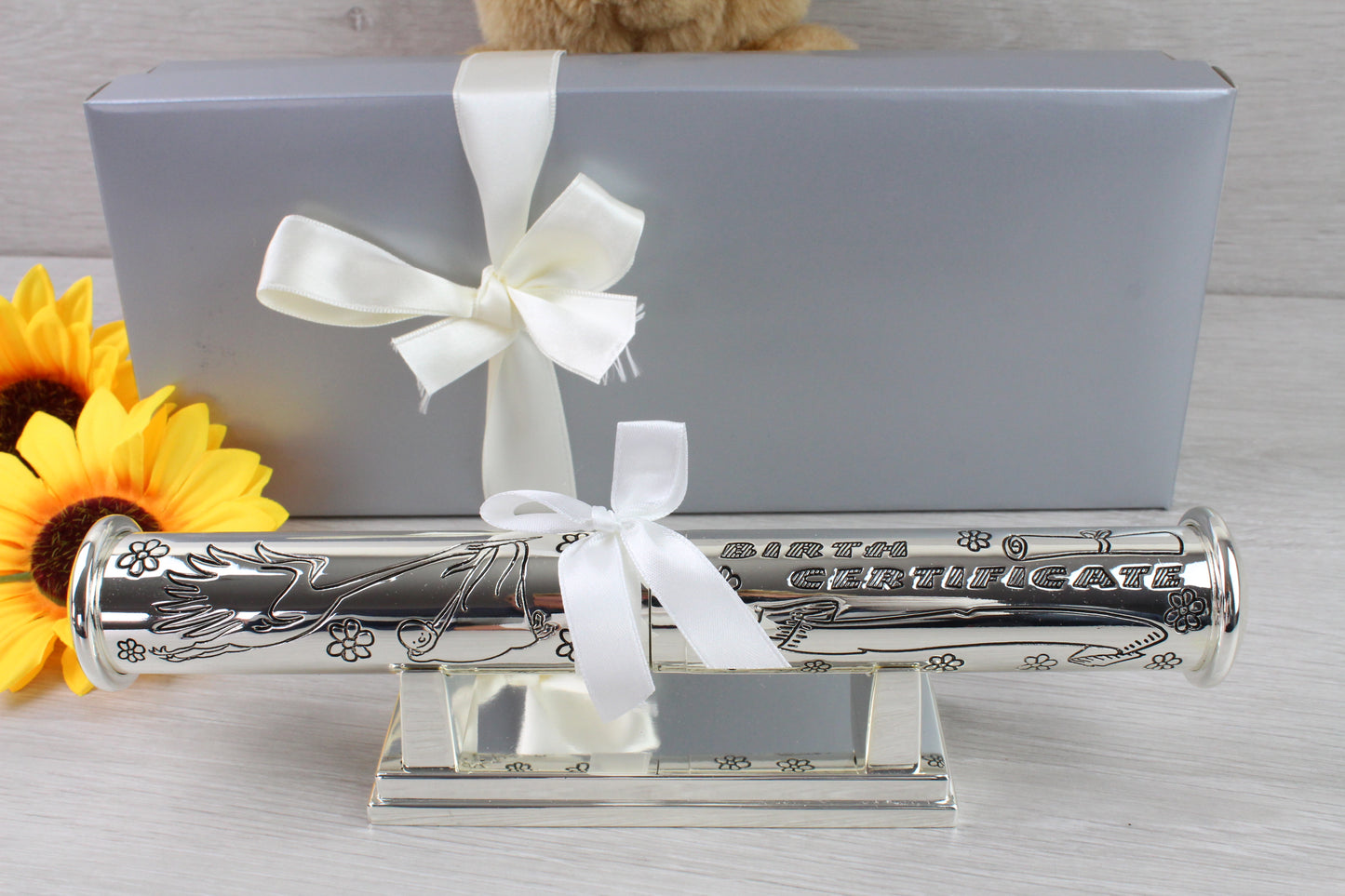 Engraved Personalised Birth Certificate Holder with Stand - Silver Plated finished with ivory ribbon and complemented with attractive, satin lined gift box. and 2 sunflower as props.