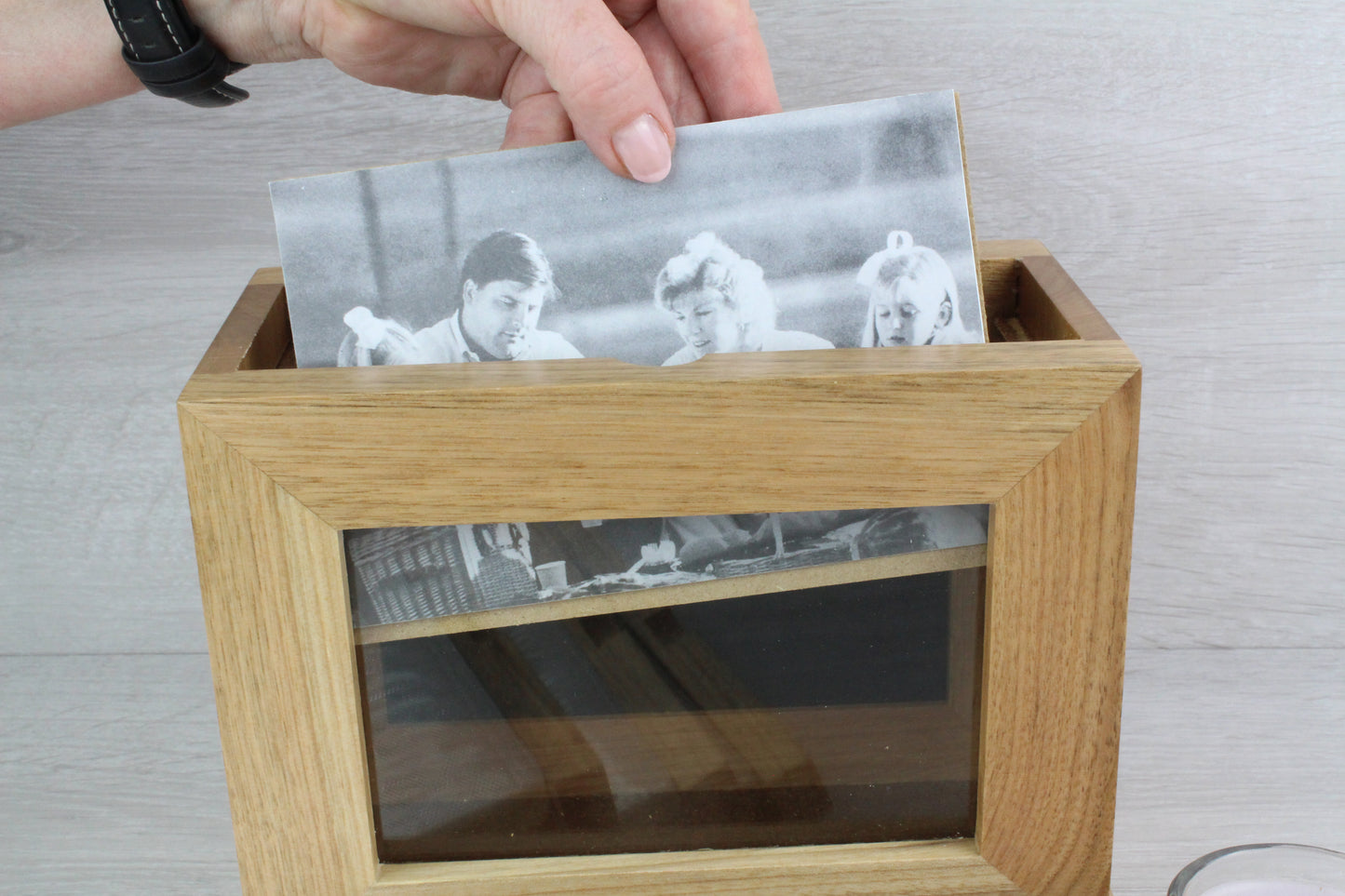 Close-up demonstration of how to insert the photo inside the Personalised Oak Wooden Photo Frame and Album Holder.