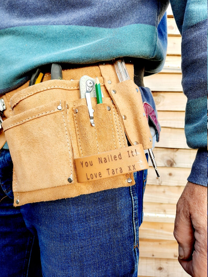 Left side of tool belt with craft knife and screwdriver in belt pockets