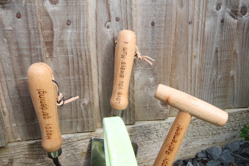 Engraved fork that says 'Happy gardening!", trowel that says "Love you always Mum x" and dibber that says "Happy Retirement!"